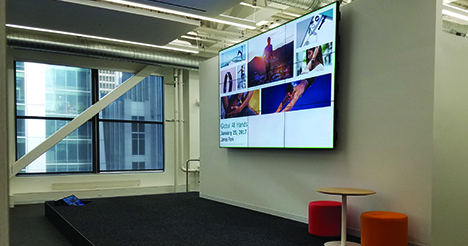 A very large monitor installed in an office