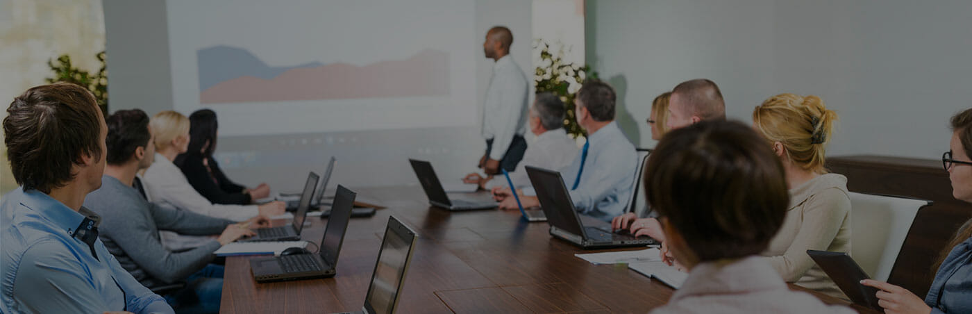 Photo of employees in an office conference room watching a presentation
